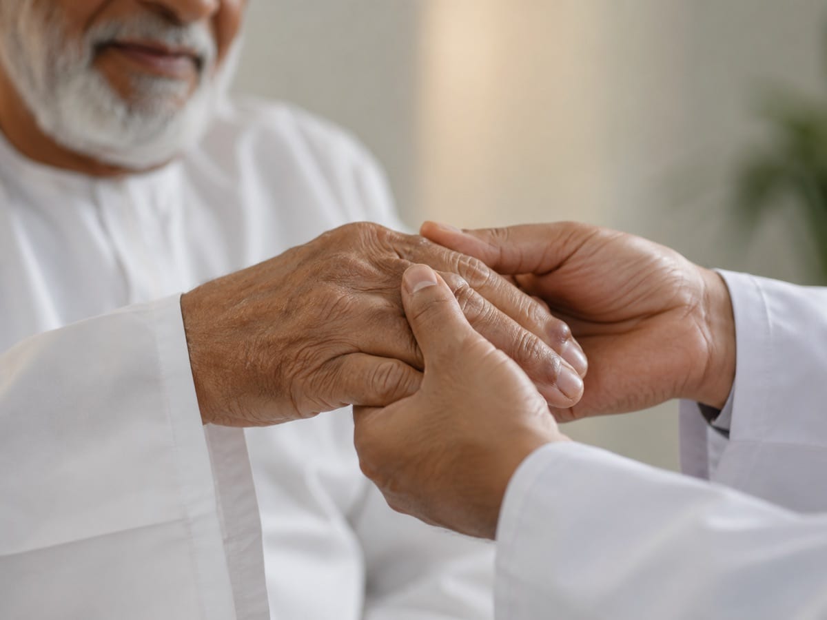 A clinician gently examining an older patient's arthritic hand.